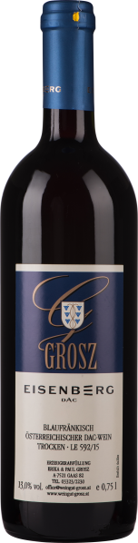 Dunkelrote Weinflasche mit blau-goldenem Etikett und Verschluss.