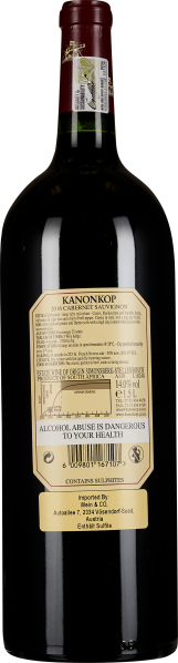 Flasche Rotwein mit tiefrotem Etikett und informativen Aufdrucken.