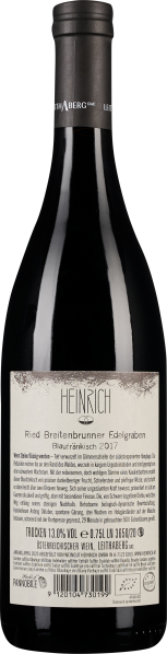 Dunkle Weinflasche mit schlichtem Etikett und schwarzem Verschluss.