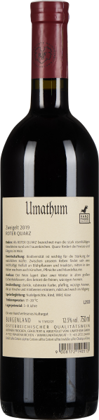 Dunkle Weinflasche mit rotem Verschluss und umfangreichem beige-farbenem Etikett.