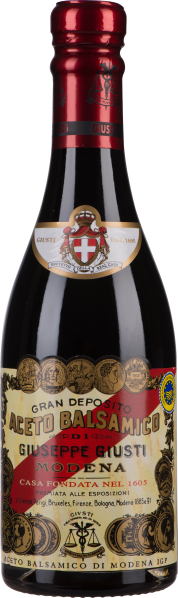 Dunkle Glasflasche mit reich verziertem Etikett und rotem Verschluss.