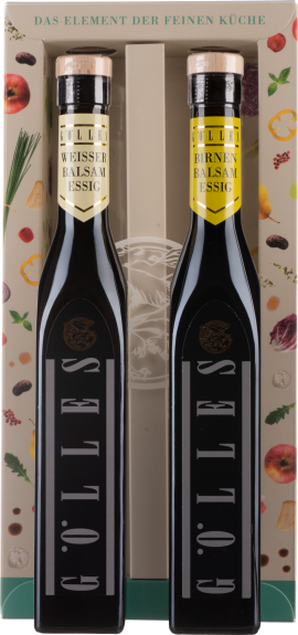 Zwei elegante, dunkle Essigflaschen in dekorativer Verpackung mit Obstmotiven.