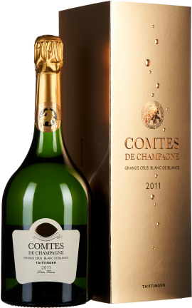 Grüne Champagnerflasche mit goldener Folie, neben edler goldener Verpackung.