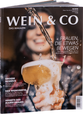 Magazin-Cover mit spritzendem Sektglas und unscharfem Hintergrund.