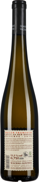 Braune Weinflasche mit schwarzem Hals und detailliertem Etikett auf der Rückseite.