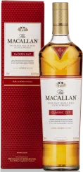 Klarer Whisky in goldener Flasche neben roter Verpackung mit edlem Design.