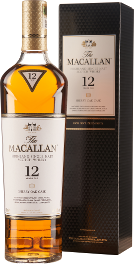 Große, elegante Whiskyflasche mit goldener Kapsel, transparentem Etikett und bernsteinfarbenem Inhalt; im Hintergrund eine stilvolle schwarze Geschenkverpackung.
