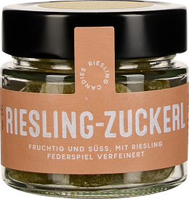 Kleines Glas mit schwarzem Deckel, transparentem Inhalt und beiger Banderole.