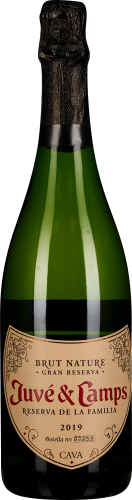 Grüne Sektflasche mit schwarzem Hals und dekorativem Etikett.