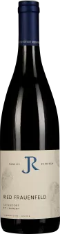 Flasche mit dunkelblauem Verschluss und cremefarbenem Etikett mit minimalistischer Gestaltung, vor schwarzem Hintergrund.
