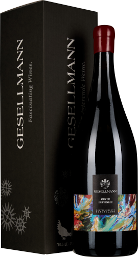 Weinflasche mit rotem Siegel, bunter Etikettendesign, schwarzer Geschenkkarton.