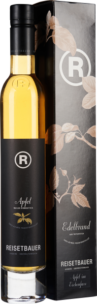 Eine schlanke, elegante Flasche mit honiggelbem Inhalt und einem schwarzen Etikett, das goldene Akzente und botanische Illustrationen zeigt. Die Flasche steht neben einer passenden schwarzen Verpackung mit Naturmotiven und einem großen, stilisierten „R“.